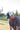 Man on a golf course wearing a cap and gray shirt